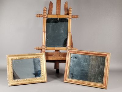 three mirrors sitting on a table with a wooden frame