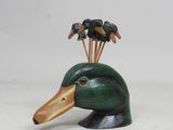 a wooden duck head with a bunch of birds on it