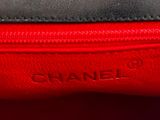 the inside of a red and black bag with the name chanel on it