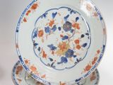 two plates and a vase sitting on a table