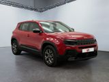 a red jeep compass suv parked in a garage