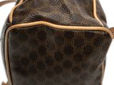 a close up of a brown and tan handbag on a white surface