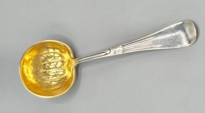 an image of a silver spoon with a yellow flower on it