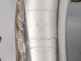 a silver saxophone that is sitting on a table
