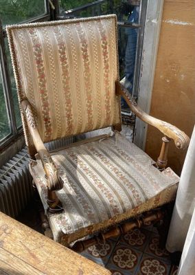 a chair that is sitting in a room by a window