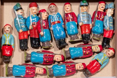 many figurines in a box that are in the shape of people