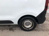the rear end of a white van parked in a parking lot