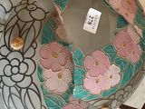 a glass bowl with flowers on it sitting on a table