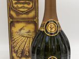an image of a bottle of champagne next to a box of chocolate