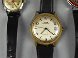 three different watches are displayed on a white surface with a black strap