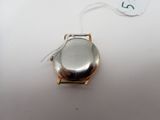 an image of a silver watch with a tag on a white surface