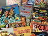 a lot of comic books that are on the table