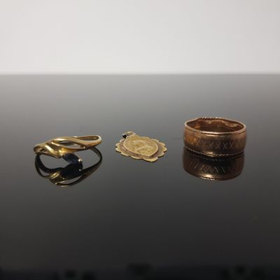 two rings and a ring on a table with a white background