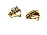 two gold rings with diamonds and a black and white diamond