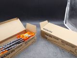 two boxes of pencils sitting next to each other on a table