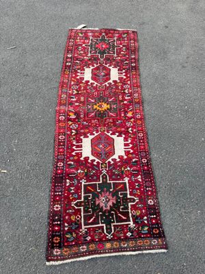 un tapis rouge posé par terre à côté d'un trottoir