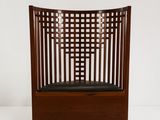 an image of a wooden chair with black leather seat