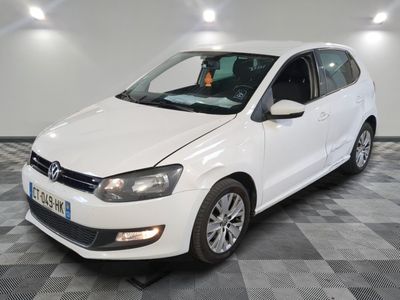 the white volkswagen polo is parked on a checkered tile floor