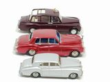 several toy cars are lined up in a row on a white surface
