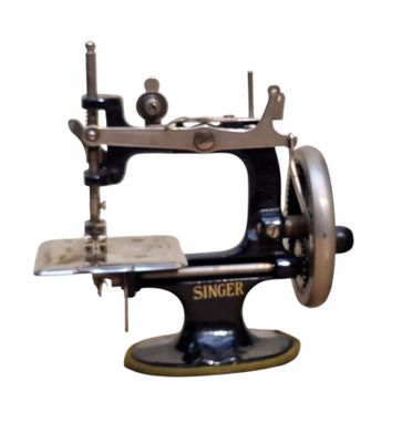 a black and silver sewing machine on a white background