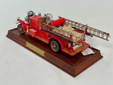 a model of a red fire truck with a ladder