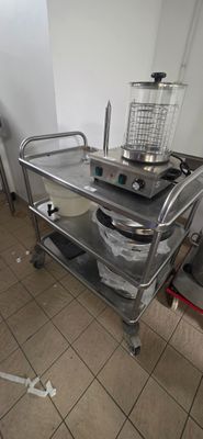a kitchen with a sink and a metal cart