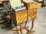 a small wooden desk with two drawers and a laptop on it