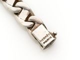 an image of a close up of a silver bracelet on a white surface