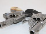 two revolvers that are sitting on a table