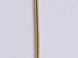 a gold spoon and a spoon rest on a white surface
