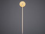 a single toothpick with a wooden handle on a gray background