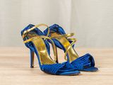a close up of a pair of blue shoes on a wooden table