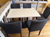 a table with four chairs around it in a room