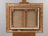 an old wooden easel with a painting on top of it