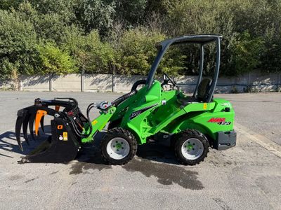 a small green tractor parked in a parking lot