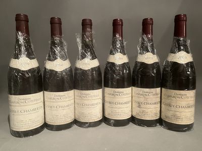 six bottles of wine are lined up in a row on a table