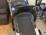 the tread machine is sitting in the corner of the room