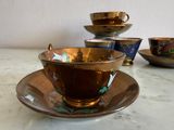 a cup and saucer sitting on a marble table