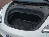 a white car with its trunk open on the street