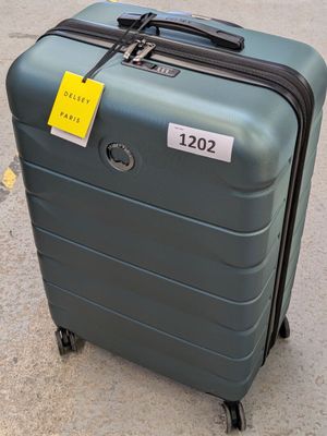 a piece of luggage sitting on the ground with a price tag on it