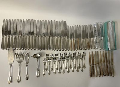 a lot of silverware on a table with a knife, fork, spoon, and spoon rest