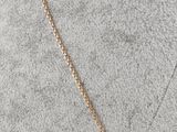 a gold chain necklace with a small diamond on top of a mannequin mannequin mannequin mannequin mannequin mannequin manne