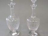 two clear glass vases sitting on top of a table