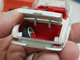 someone is holding a toy car with a wedding ring inside of it