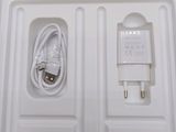 a white box containing a charger and a cord