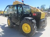 a picture of a yellow tractor parked in a parking lot