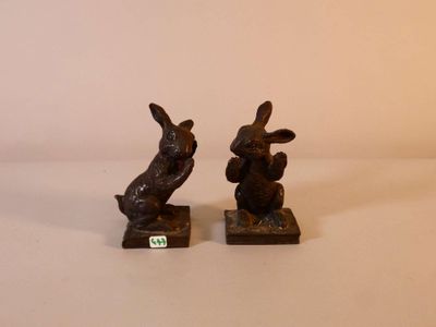 two figurines of rabbits sitting on top of each other