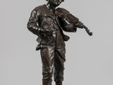 bronze statue of a man playing a violin on a pedestal