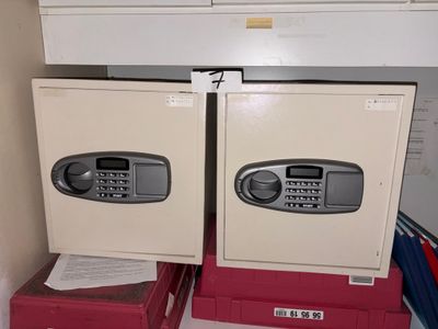 two safe boxes sitting on top of each other in a closet