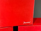 three red boxes are stacked on top of each other on a table